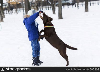 Kid of school age with dog in winter park. My best friend and I