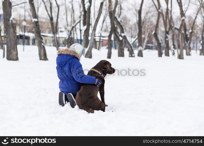 Kid of school age with dog in winter park. My best friend and I