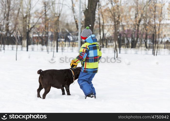 Kid of school age with dog in winter park. My best friend and I