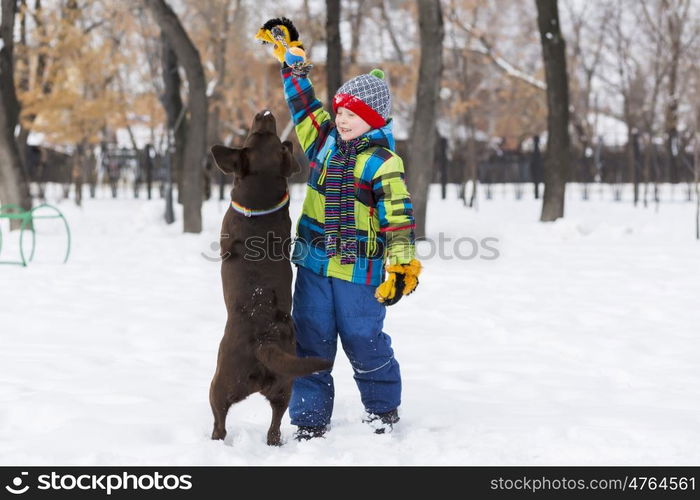 Kid of school age with dog in winter park. My best friend and I