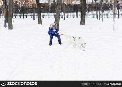 Kid of school age with dog in winter park. My best friend and I