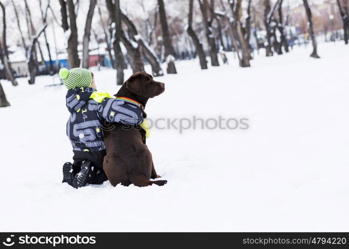 Kid of school age with dog in winter park. My best friend and I