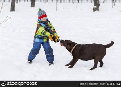 Kid of school age with dog in winter park. My best friend and I