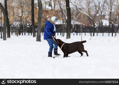 Kid of school age with dog in winter park. My best friend and I