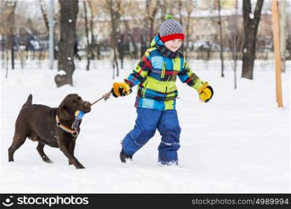 Kid of school age with dog in winter park. My best friend and I