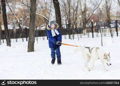 Kid of school age with dog in winter park. My best friend and I