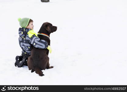 Kid of school age with dog in winter park. My best friend and I