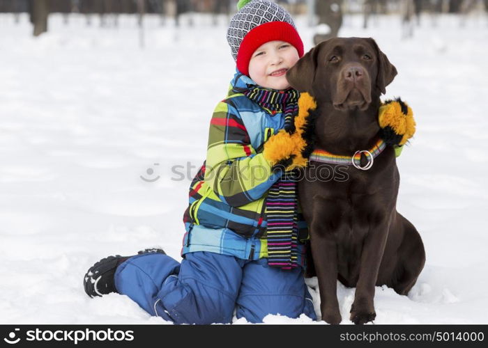 Kid of school age with dog in winter park. My best friend and I