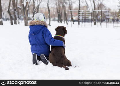 Kid of school age with dog in winter park. My best friend and I