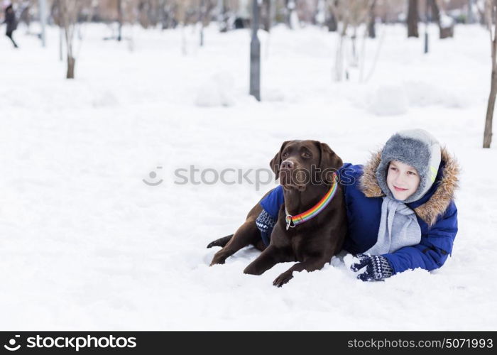 Kid of school age with dog in winter park. My best friend and I