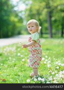 Kid on dandelions field