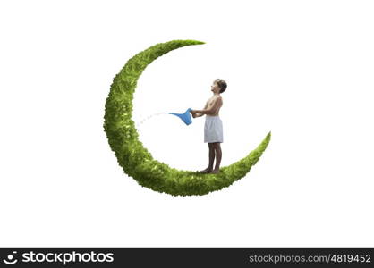 Kid on moon. Little boy standing on moon with can in hands