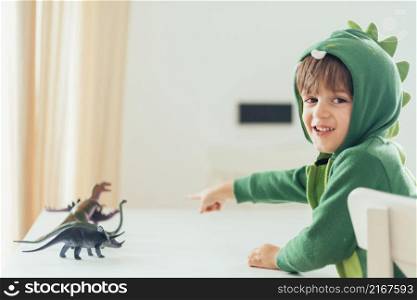 kid playing with toy dinosaurs