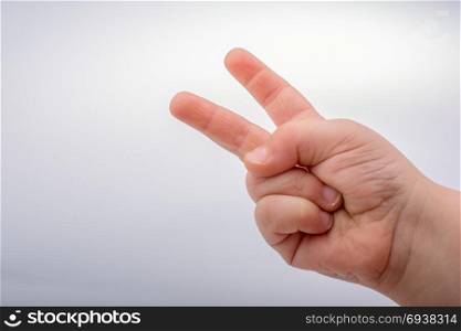 Kid&rsquo;s hand making a number two gesture