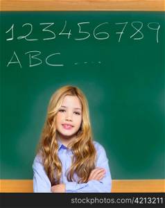 kid student girl on green school blackboard and chalk written letters and numbers