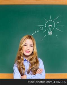 kid student girl on green school blackboard and drawn light bulb idea