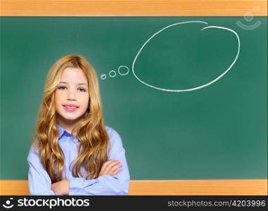 kid student girl on green school blackboard having a good idea