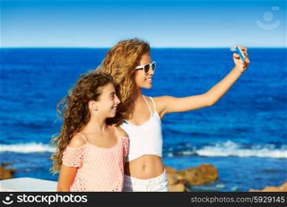 kid teen friend girls photo selfie on smartphone in a each at Mediterranean