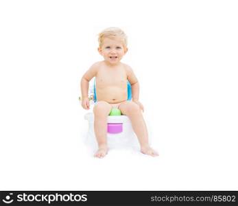 Kid white caucasian smiling and sitting on the potty with white background.