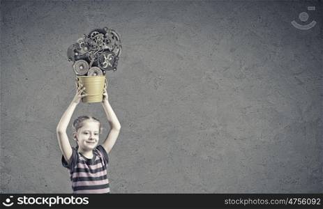 Kid with bucket. Cute girl of school age holding yellow bucket