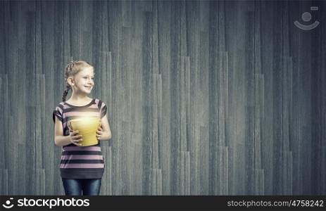 Kid with bucket. Cute girl of school age holding yellow bucket