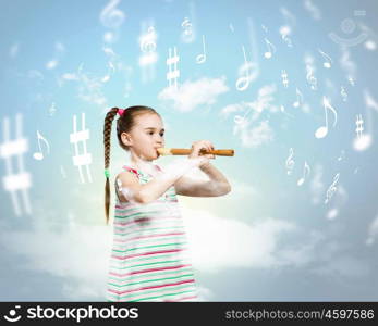 Kid with flute. Image of little cute girl playing on flute