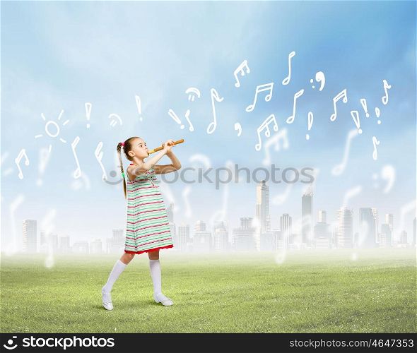 Kid with flute. Image of little cute girl playing on flute