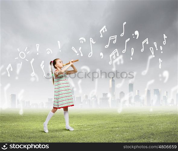 Kid with flute. Image of little cute girl playing on flute