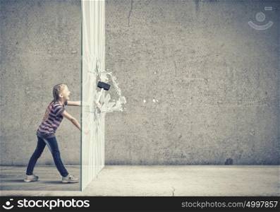 Kid with hammer. Cute little girl crushing cement wall with hammer