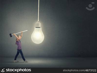 Kid with hammer. Cute little girl crushing light bulb with hammer