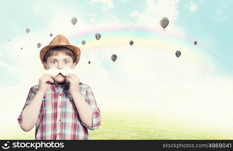 Kid with mustache. Cute boy wearing shirt and paper mustache