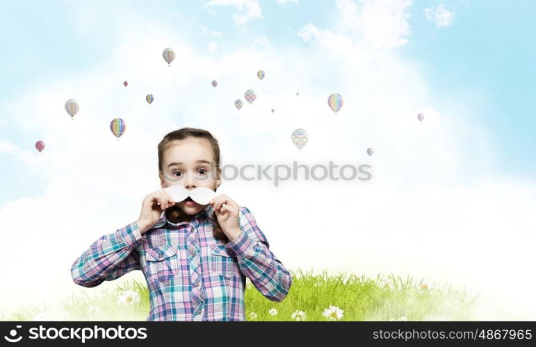 Kid with mustache. Cute girl wearing shirt and paper mustache