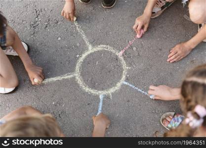 kids drawing sun with chalk. High resolution photo. kids drawing sun with chalk. High quality photo