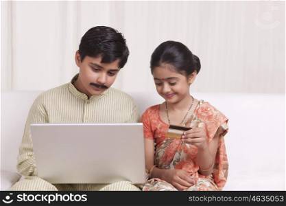 Kids dressed as husband and wife shopping online
