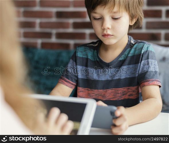 kids holding devices indoors