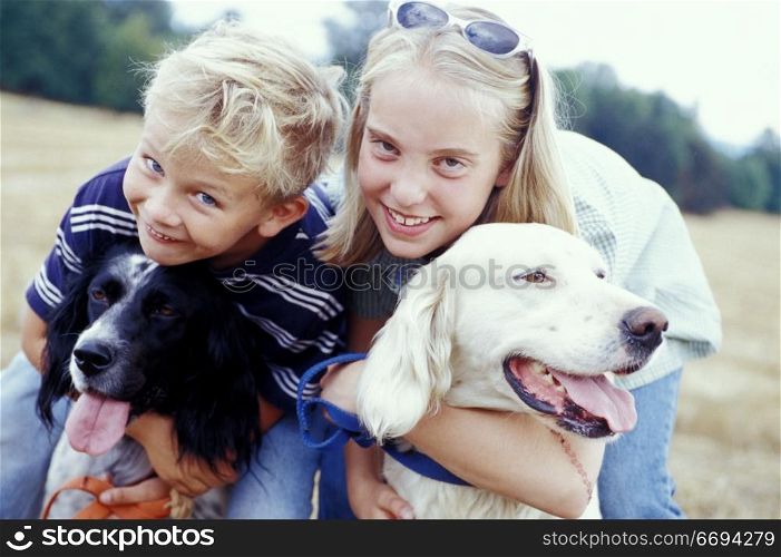 Kids Hugging Dogs