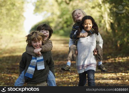 Kids in piggyback races on country lane