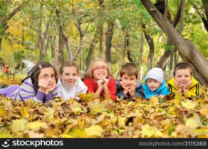 kids lying on leaves