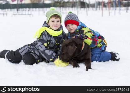 Kids of school age with dog in winter park. My best friend and I