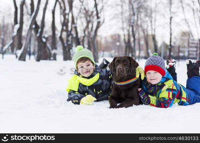 Kids of school age with dog in winter park. My best friend and I