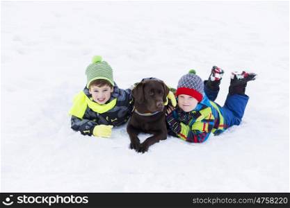 Kids of school age with dog in winter park. My best friend and I