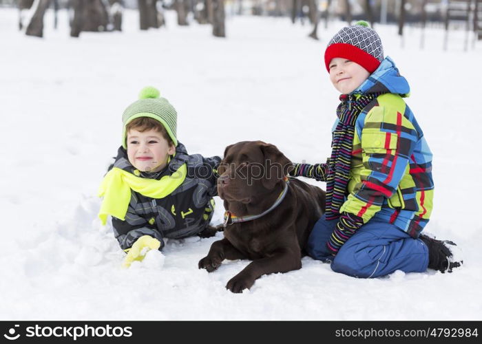 Kids of school age with dog in winter park. My best friend and I