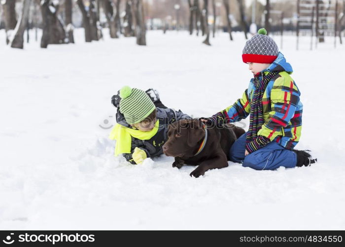 Kids of school age with dog in winter park. My best friend and I