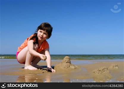 Kids on the beach, Young Girl Playing In The Sand, to make sandcastles