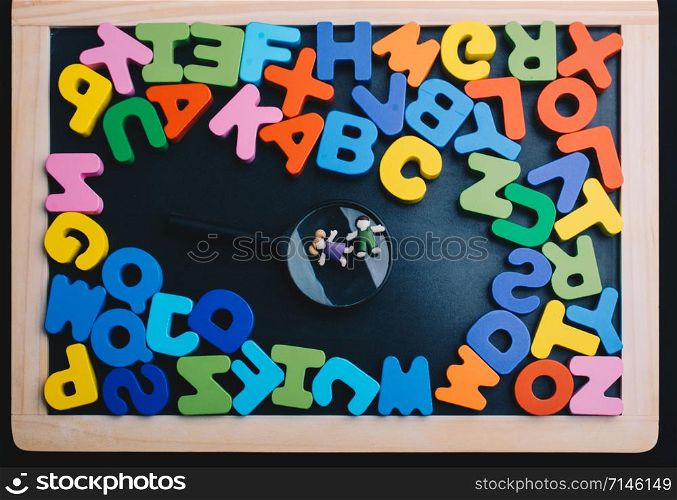 Kids over Magnifying glass and Colorful Letters of Alphabet