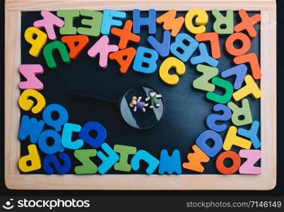 Kids over Magnifying glass and Colorful Letters of Alphabet