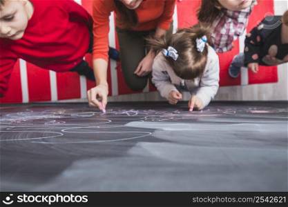 kids painting blackboard