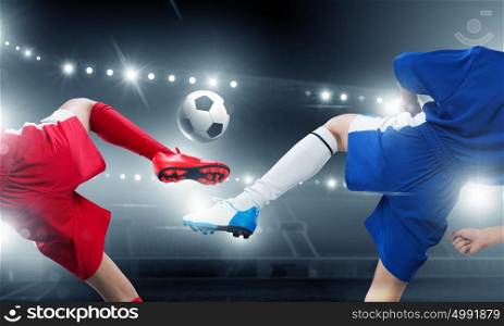 Kids play soccer on stadium . Kid boy in red uniform on soccer stadium kicking ball