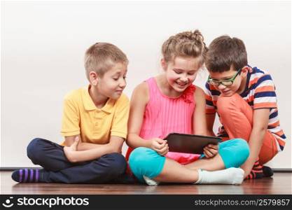 Kids playing on tablet.. Kids playing on tablet. Having fun and learning