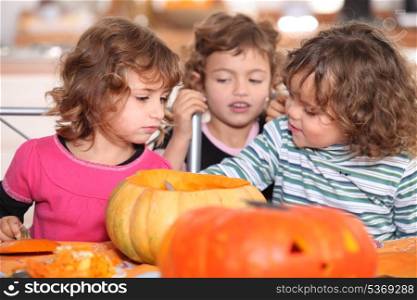 Kids preparing pumpkins for Halloween